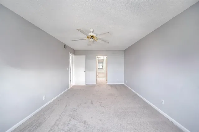 a bathroom with a granite countertop sink a mirror and a bathtub
