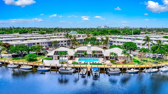 a view of swimming pool with outdoor seating and plants