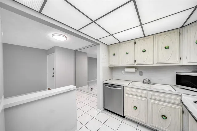 a kitchen with white cabinets and white appliances