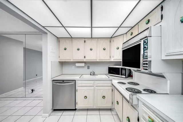 a kitchen with a stove a sink and a refrigerator