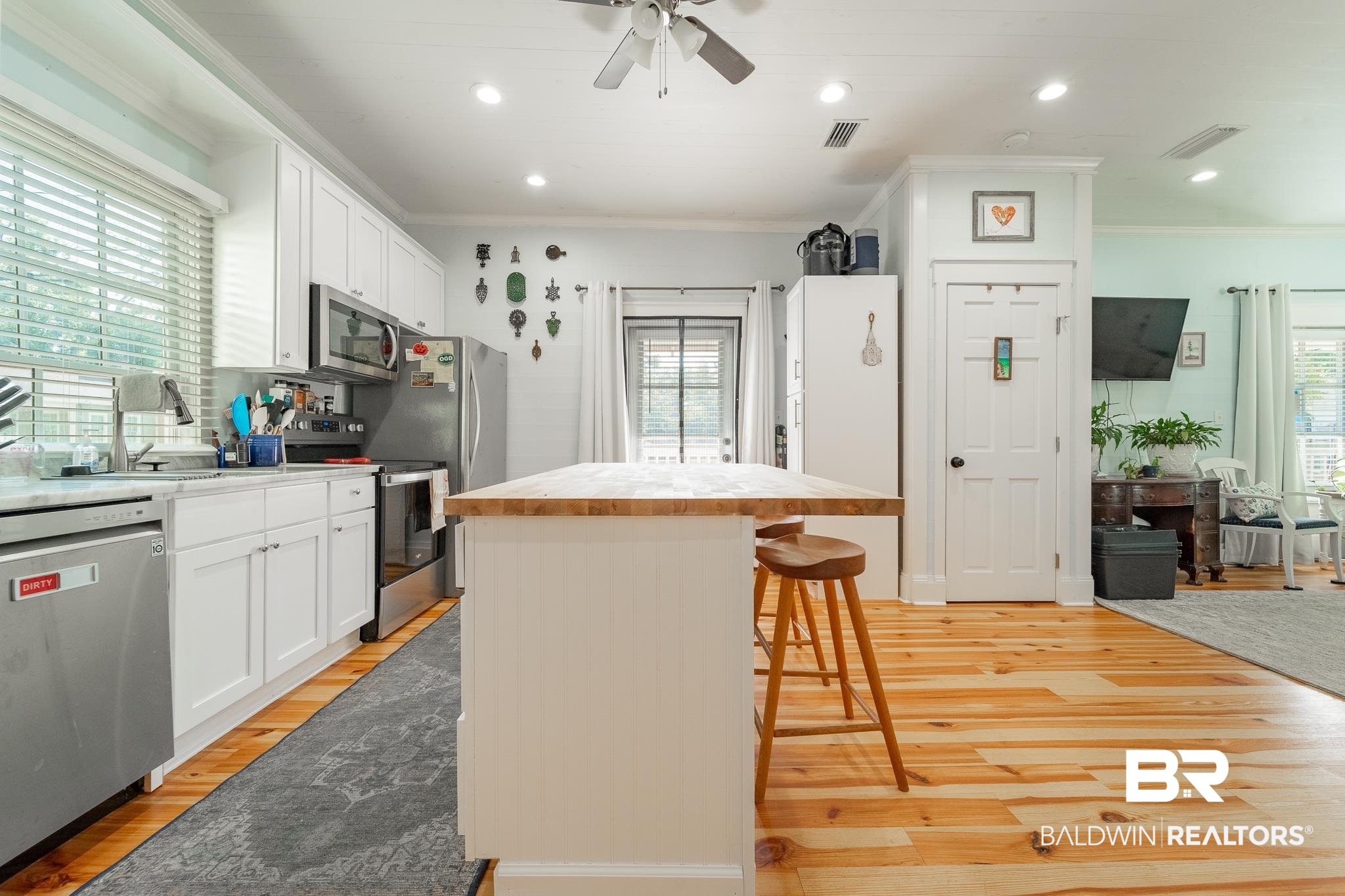 950 Texas Street Mobile, AL 36604 - Photo 8 of 17 Kitchen featuring a center island, white cabinetry, a healthy amount of sunlight, and stainless steel appliances