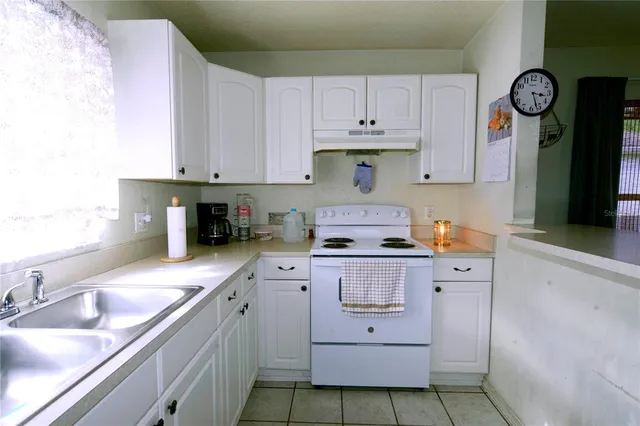 a kitchen with cabinets appliances and a sink
