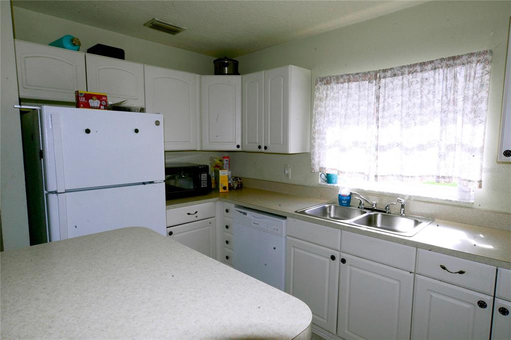 122 Ullian Trail, Unit A&B Palm Coast, FL 32164 - Photo 16 of 32 a kitchen with cabinets appliances and a window