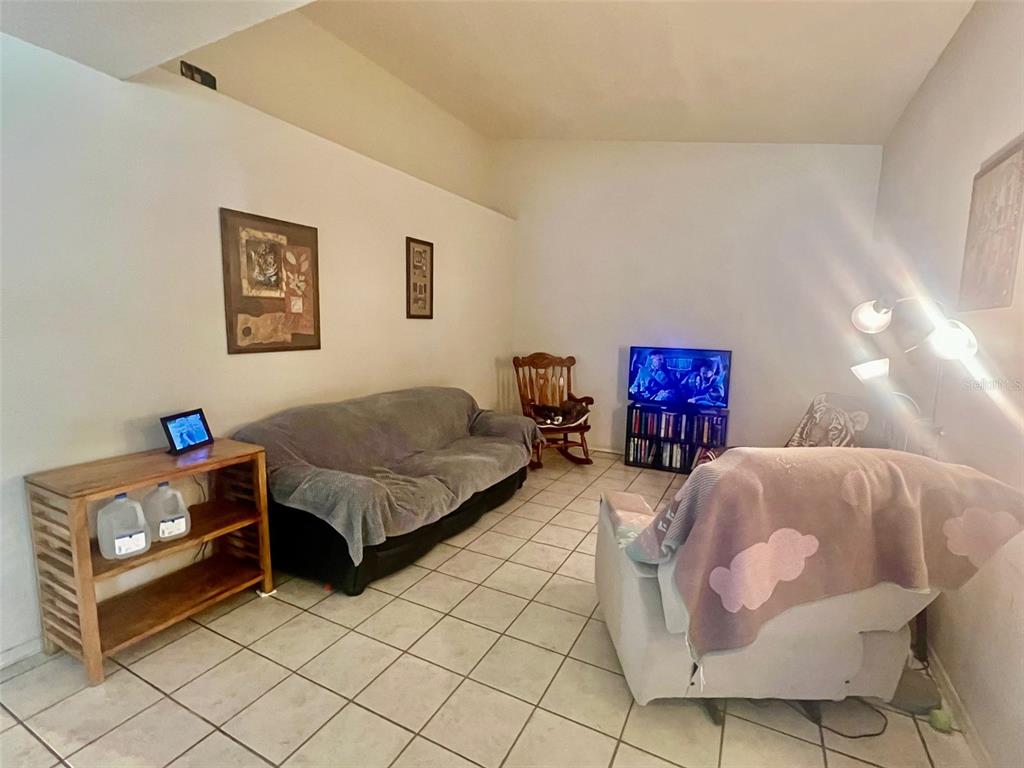 122 Ullian Trail, Unit A&B Palm Coast, FL 32164 - Photo 17 of 32 a bedroom with a bed and a potted plant