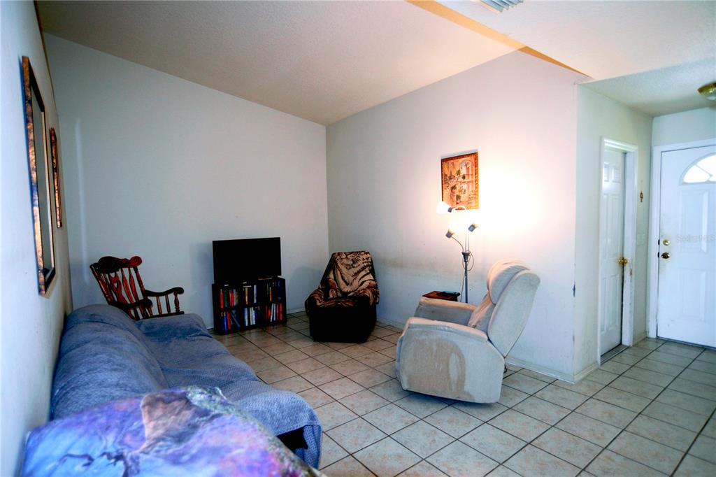 122 Ullian Trail, Unit A&B Palm Coast, FL 32164 - Photo 19 of 32 a living room with furniture and a flat screen tv