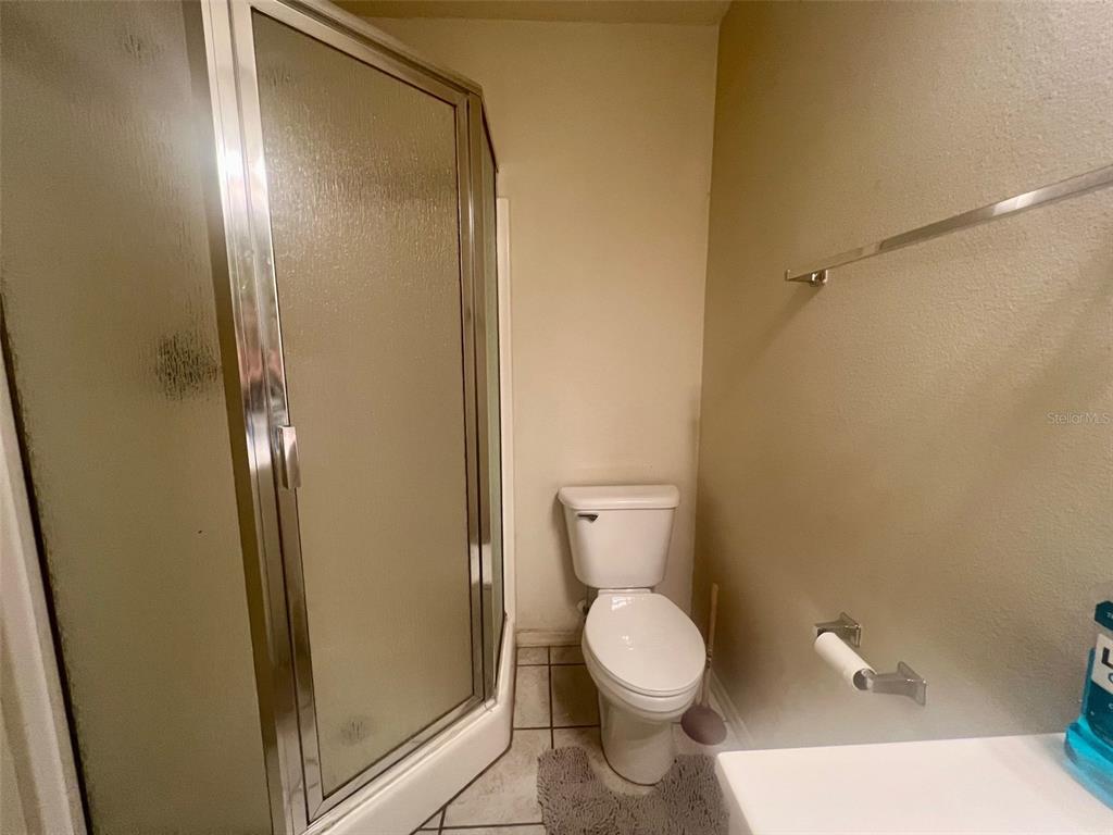 122 Ullian Trail, Unit A&B Palm Coast, FL 32164 - Photo 30 of 32 a bathroom with a toilet and a mirror