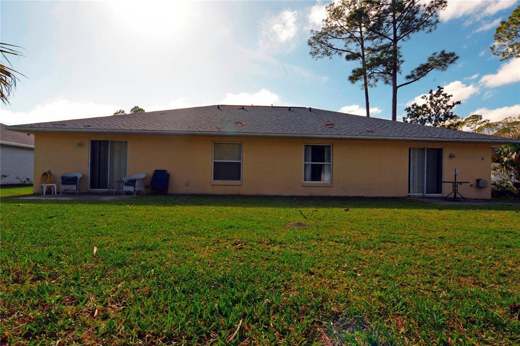 122 Ullian Trail, Unit A&B Palm Coast, FL 32164 - Photo 8 of 32 a view of a house with backyard and garden