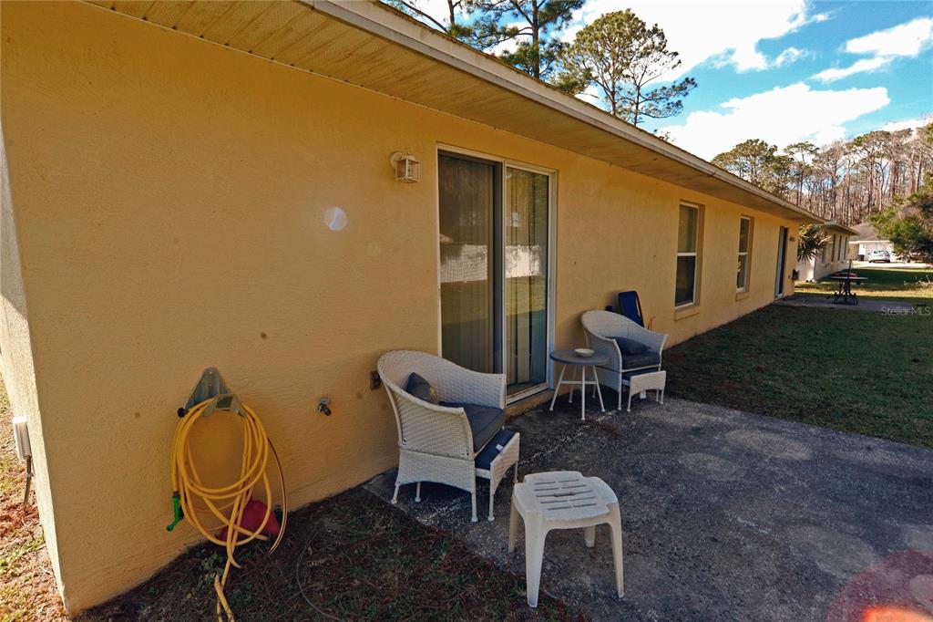 122 Ullian Trail, Unit A&B Palm Coast, FL 32164 - Photo 10 of 32 a backyard with table and chairs