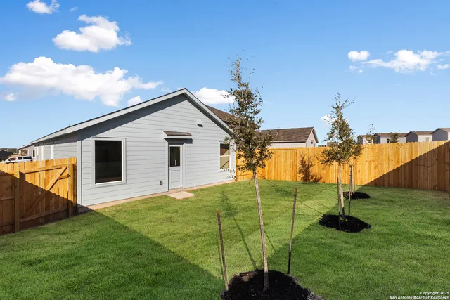 a backyard of a house with table and chairs