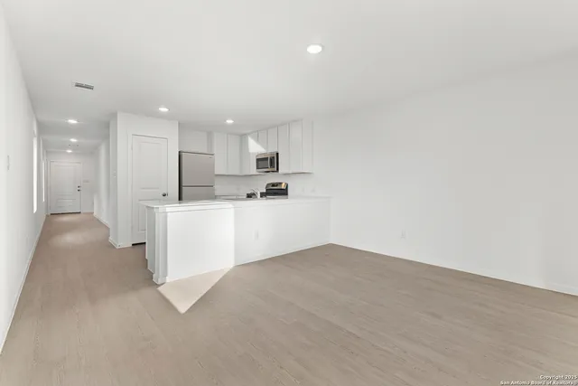 a view of a kitchen with white cabinets