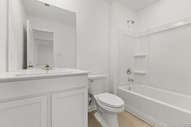a bathroom with a sink a toilet and bathtub
