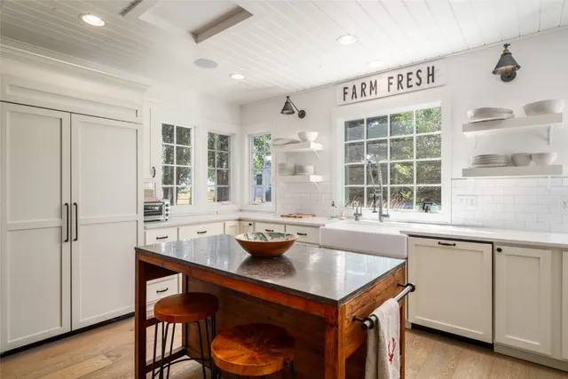 a kitchen with a sink cabinets and wooden floor