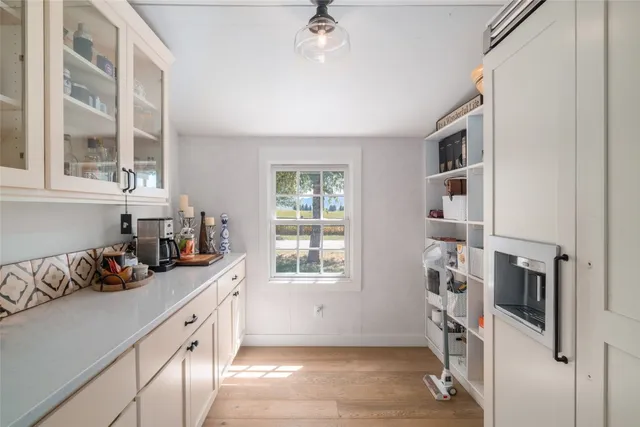 a kitchen with stainless steel appliances a cabinets and a window