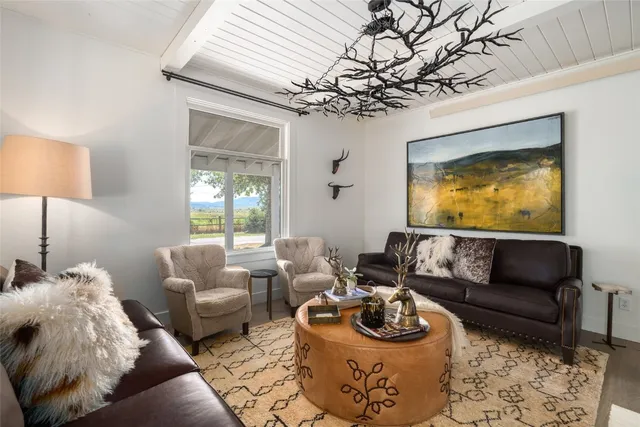 a living room with furniture and a chandelier