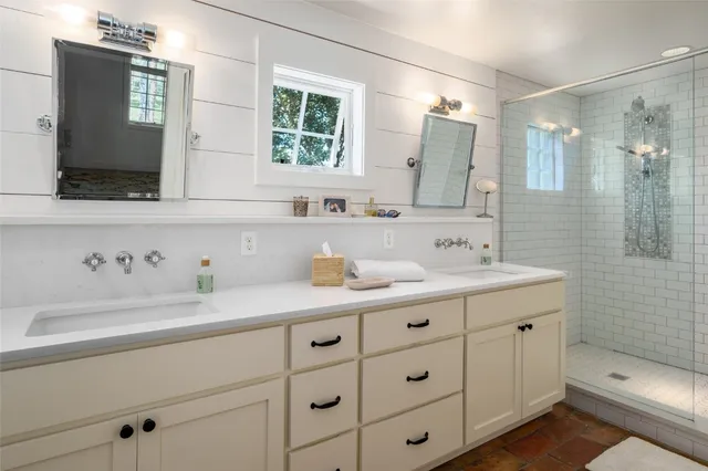 a bathroom with a double vanity sink mirror and double