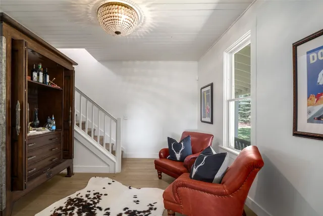 a living room with furniture a rug and a window