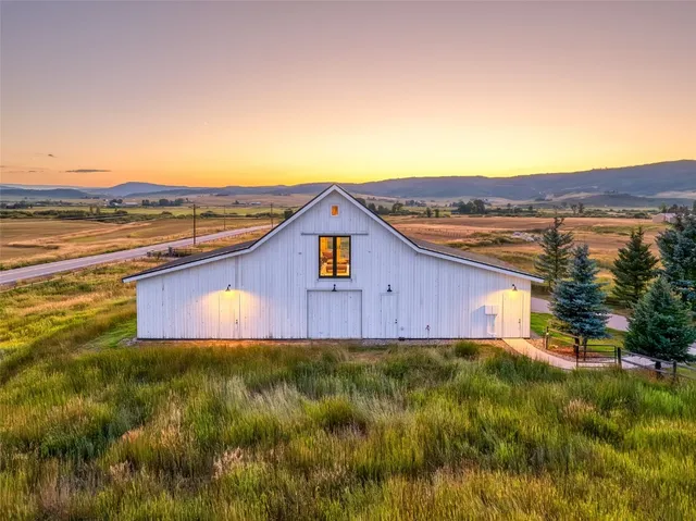 a view of a big house with a yard