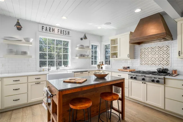 a kitchen with a stove a sink and a refrigerator