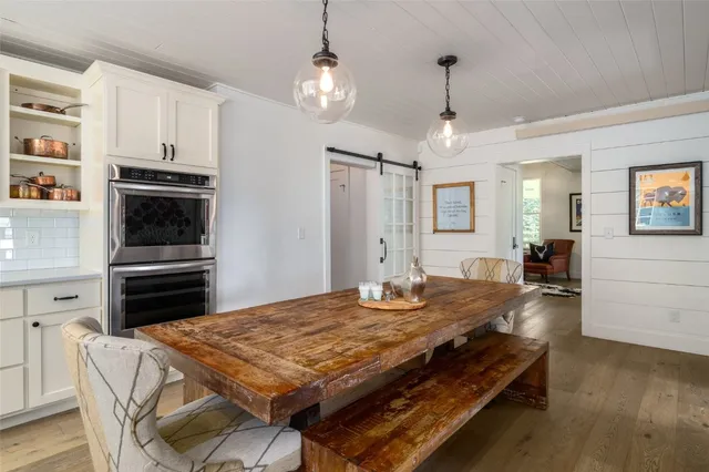 a kitchen with kitchen island a sink stove and refrigerator