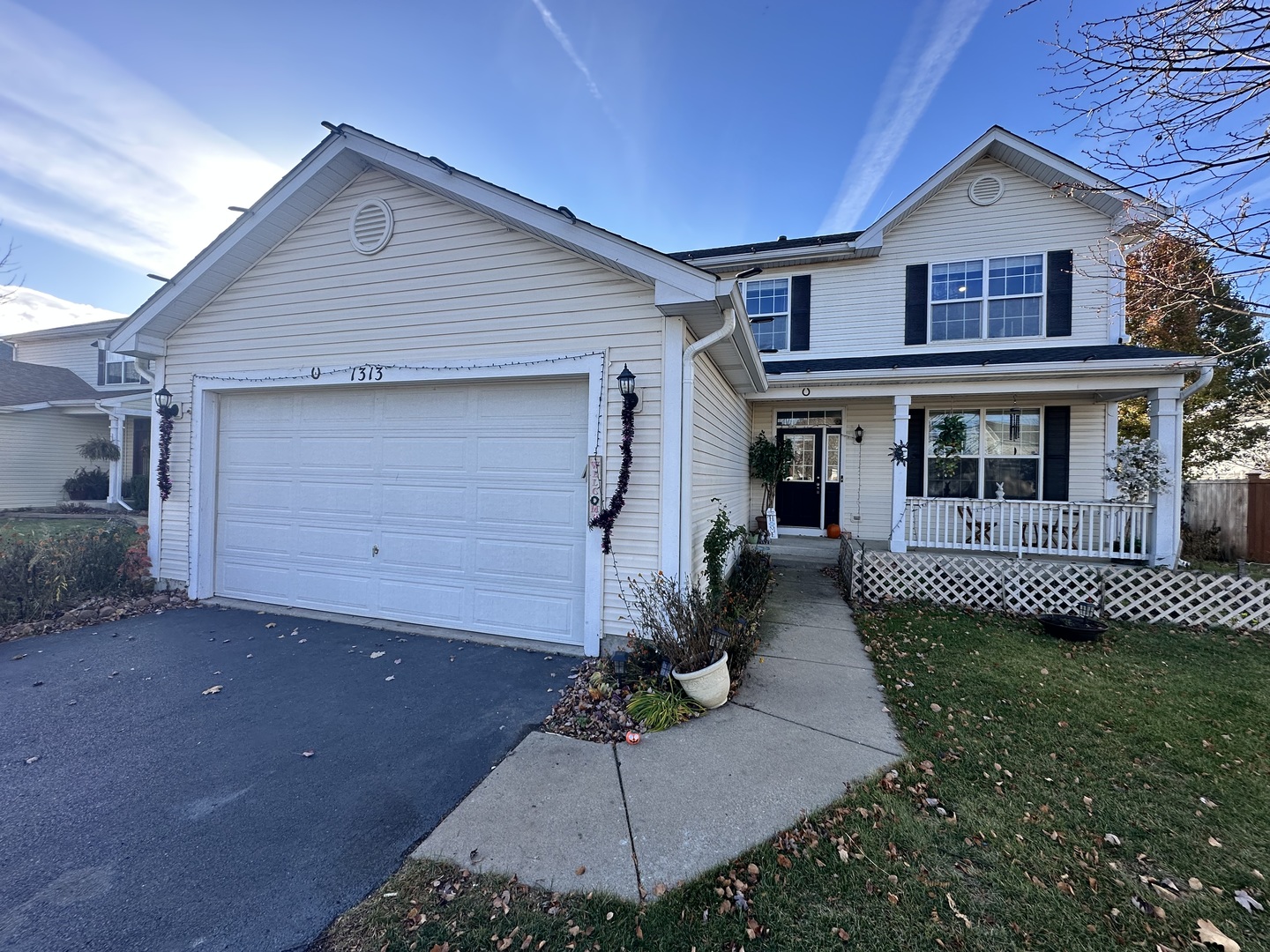 1313 Roth Drive Joliet, IL 60431 - Photo 1 of 22 a front view of a house with a garden