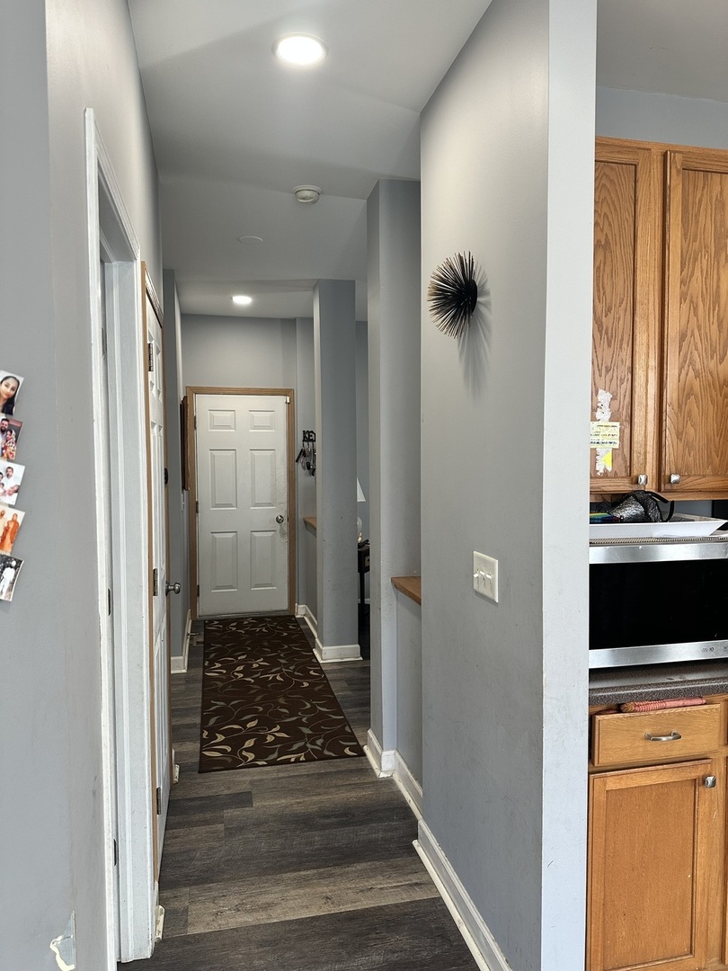 1313 Roth Drive Joliet, IL 60431 - Photo 12 of 22 a view of a hallway with wooden floor and a bathroom