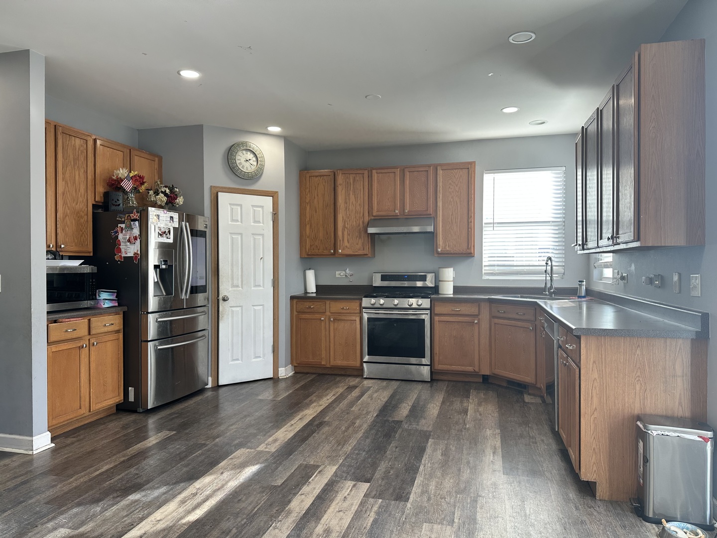 1313 Roth Drive Joliet, IL 60431 - Photo 13 of 22 a view of a kitchen with a sink refrigerator and wooden floor