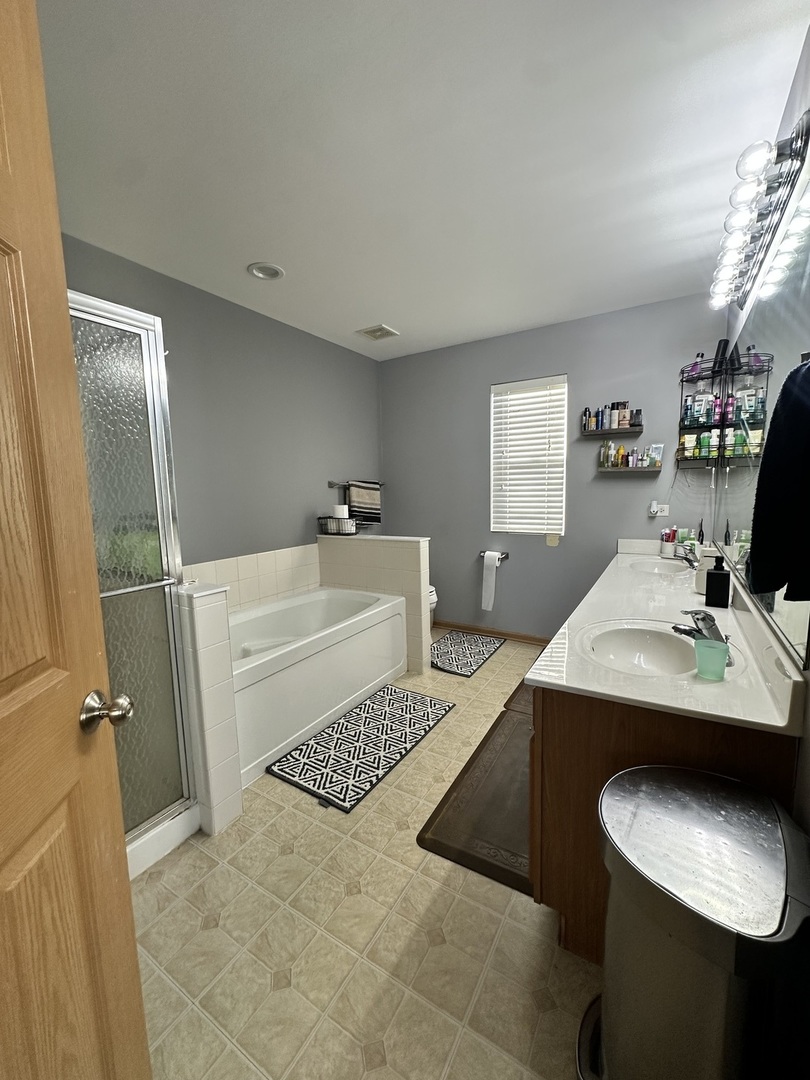 1313 Roth Drive Joliet, IL 60431 - Photo 21 of 22 a bathroom with a sink toilet and mirror