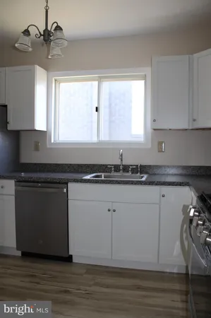 a kitchen with a sink cabinets and window
