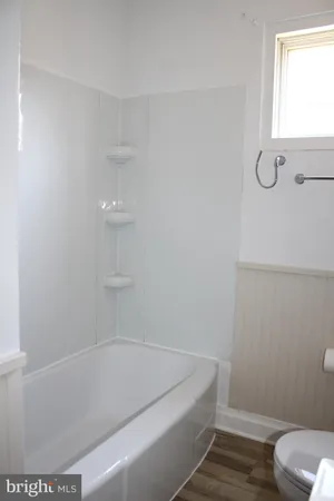 a bathroom with a bathtub and toilet
