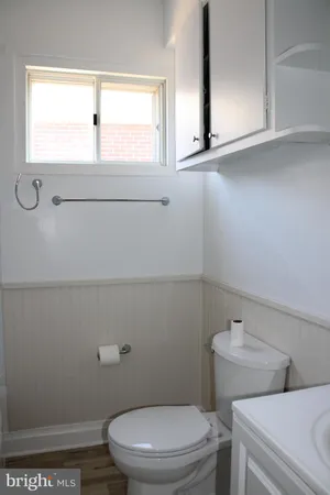 a bathroom with a toilet sink and window