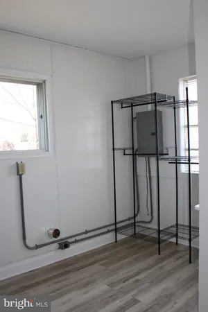 a view of a room with wooden floor and windows