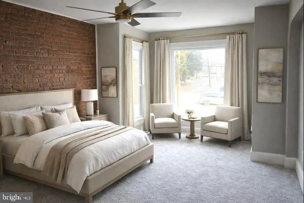 a bedroom with bed couch and window
