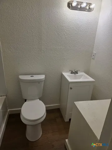 a white toilet sitting next to a white sink