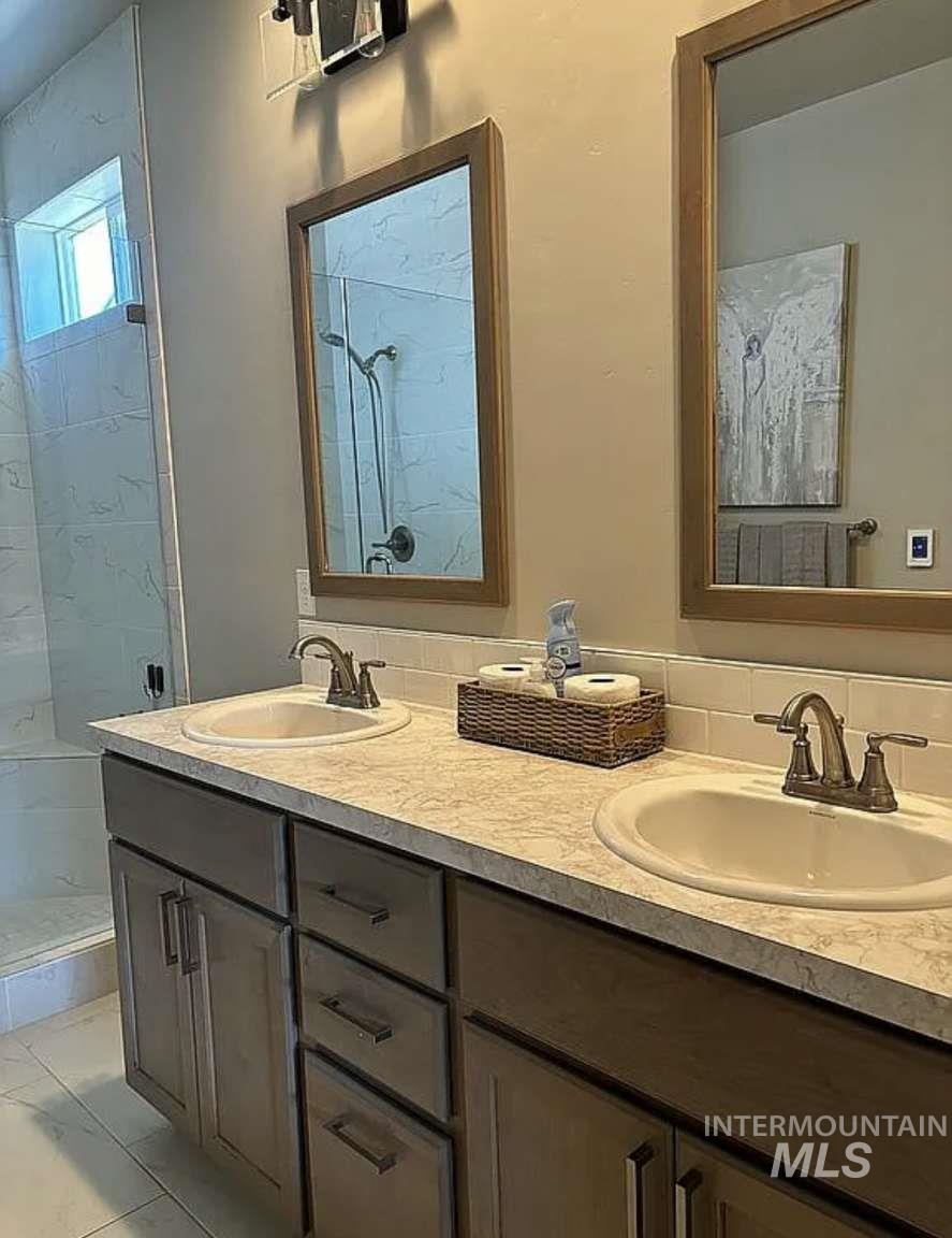 5773 West Riva Capri Street Meridian, ID 83646 - Photo 2 of 4 Full bathroom with double vanity and a shower stall