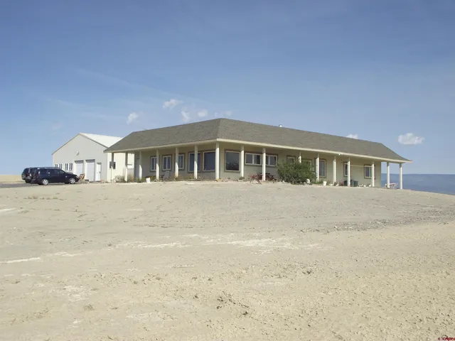 a big house with a bed and wooden fence