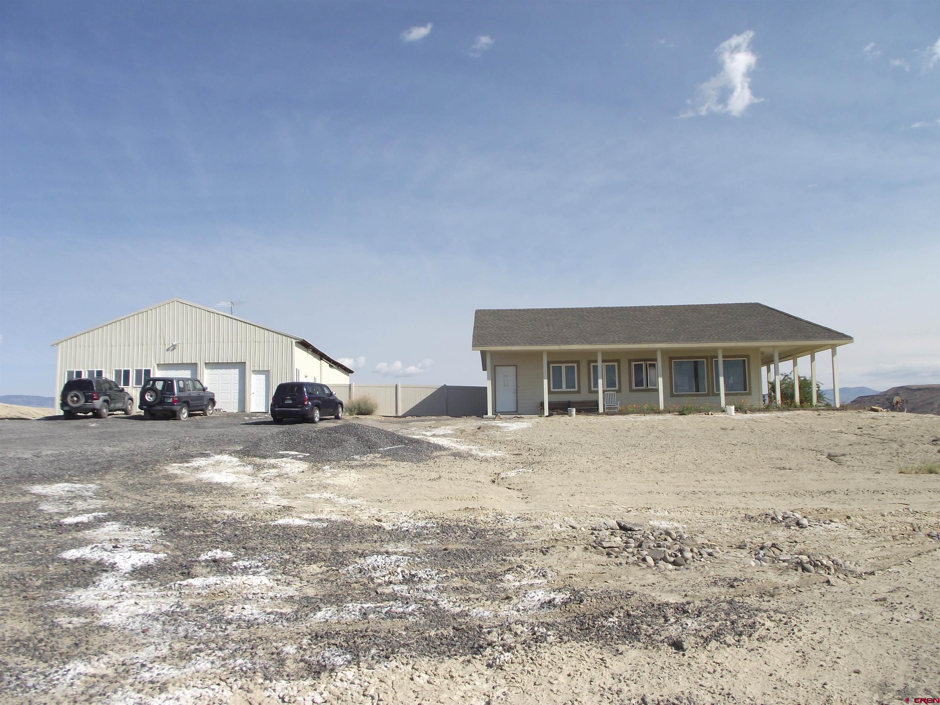 6742 2200th Road Delta, CO 81416 - Photo 13 of 45 a view of a house with a yard and large tree