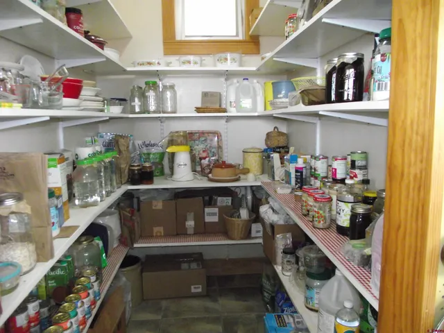 a kitchen with stainless steel appliances granite countertop a refrigerator and a table