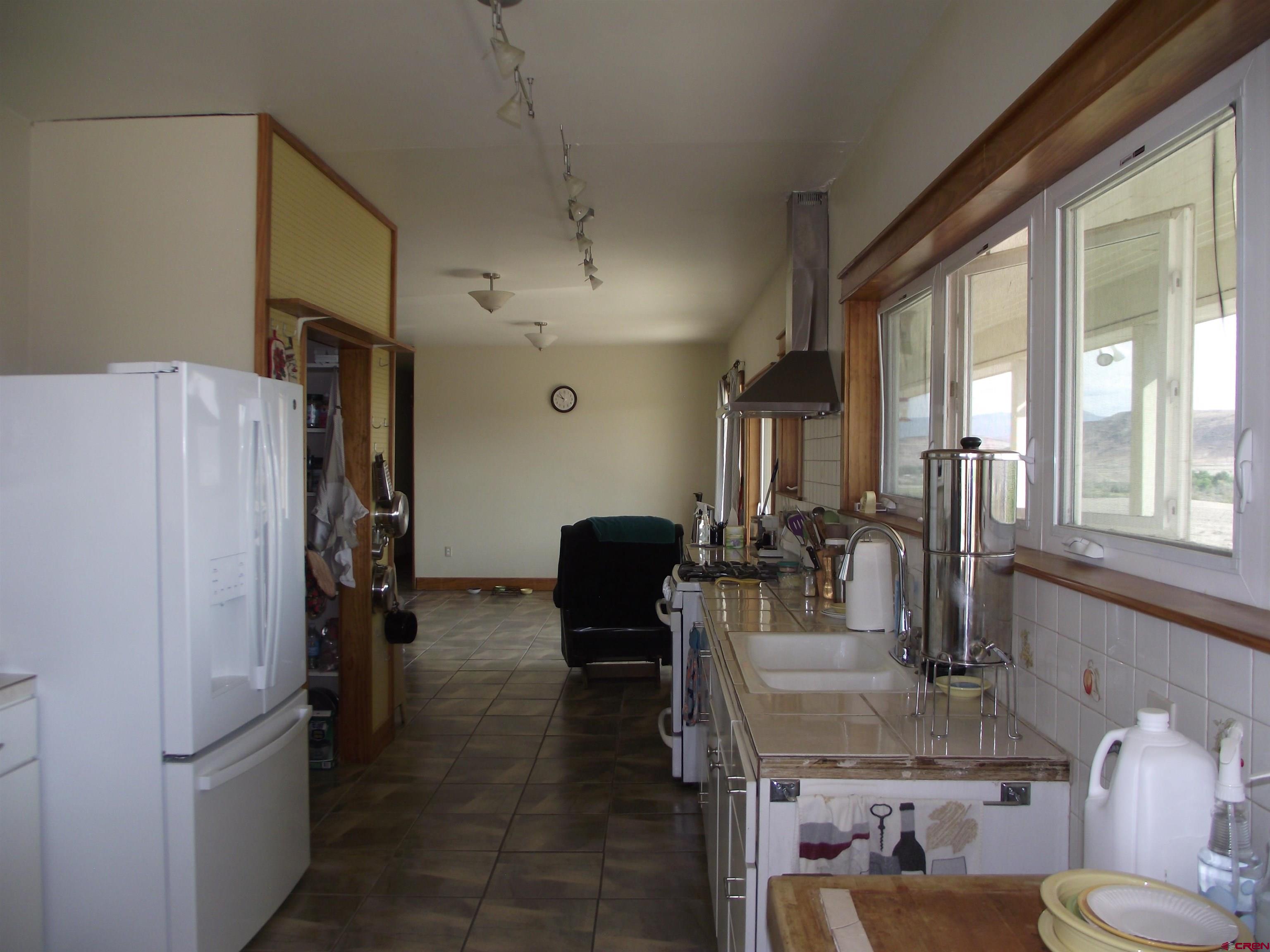 6742 2200th Road Delta, CO 81416 - Photo 24 of 45 a kitchen with refrigerator and window