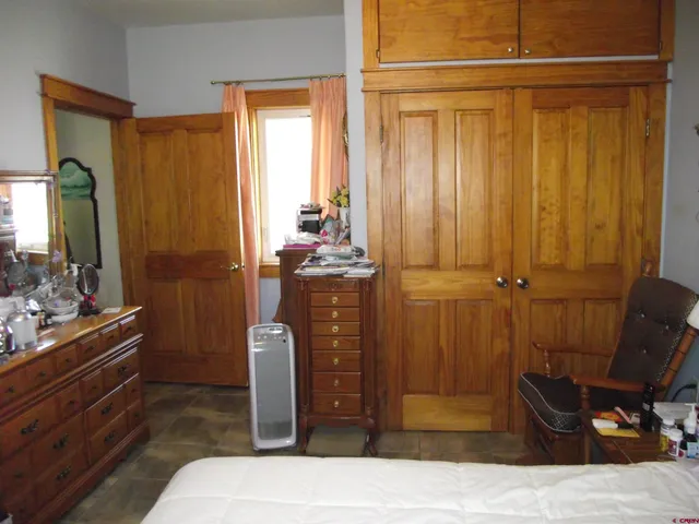 a bedroom with a bed and a closet