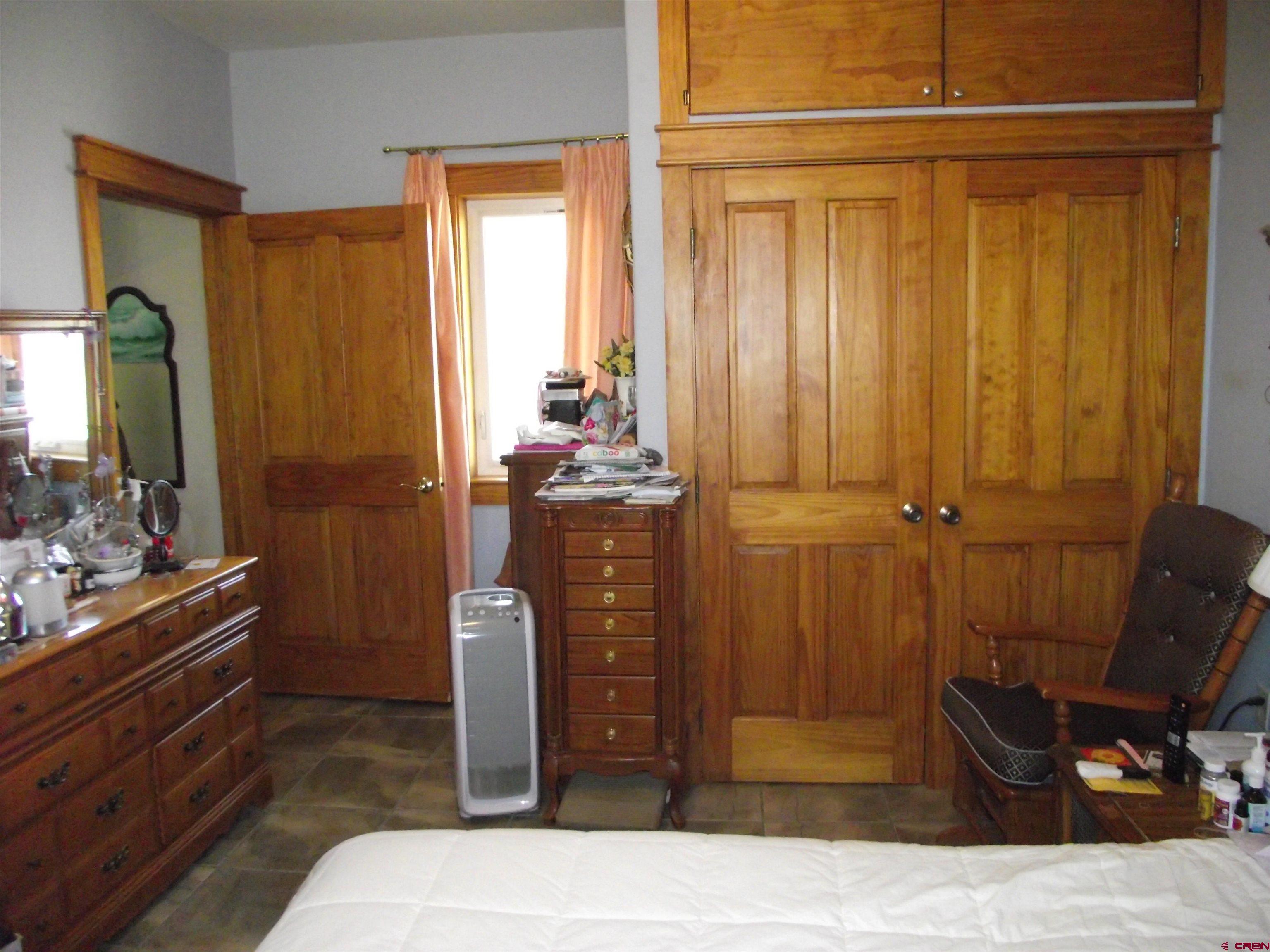 6742 2200th Road Delta, CO 81416 - Photo 29 of 45 a bedroom with a bed and a mirror