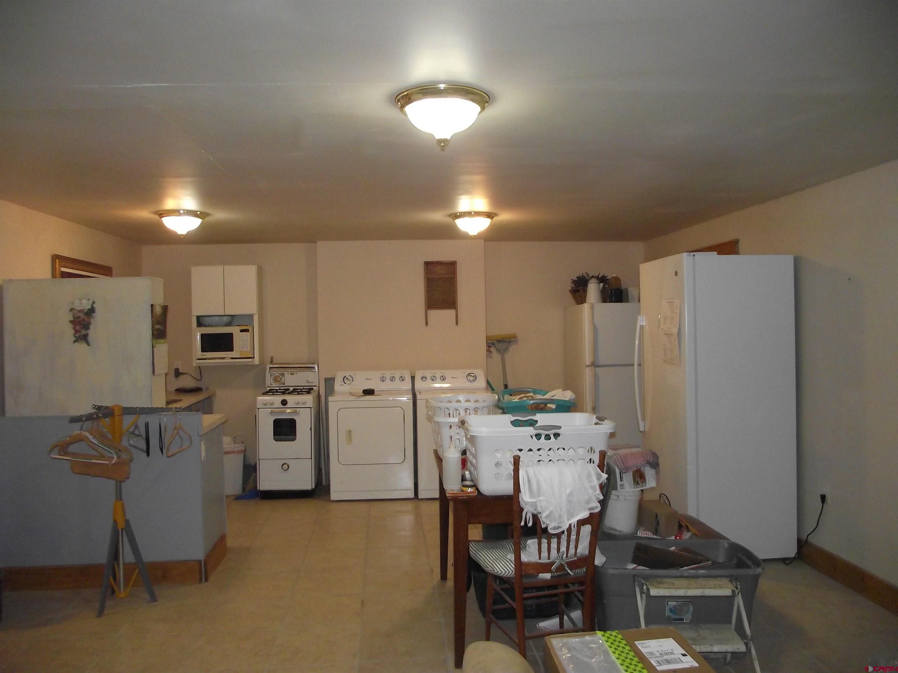 6742 2200th Road Delta, CO 81416 - Photo 40 of 45 a view of a kitchen with refrigerator and dining table