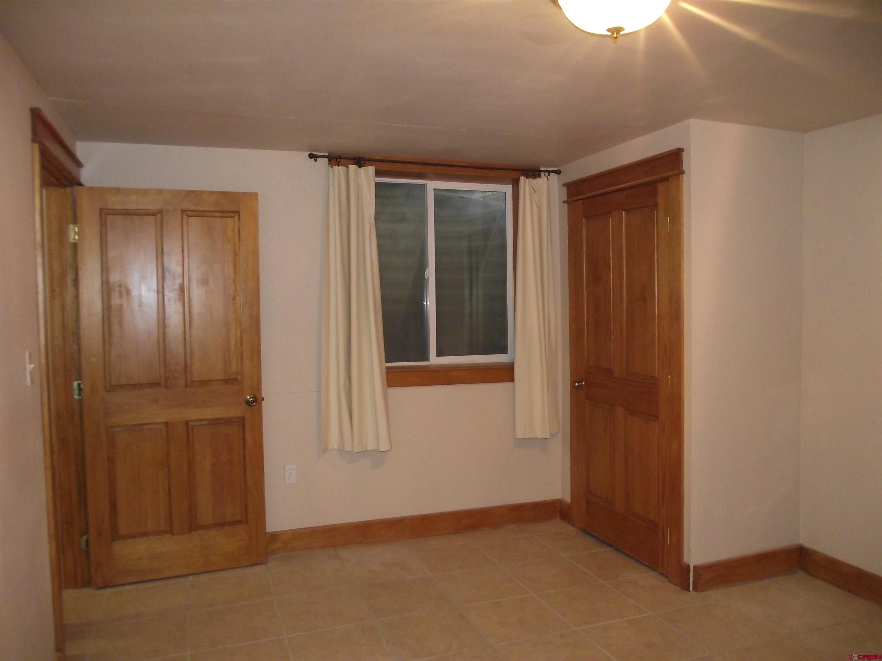 6742 2200th Road Delta, CO 81416 - Photo 44 of 45 an empty room with windows and closet