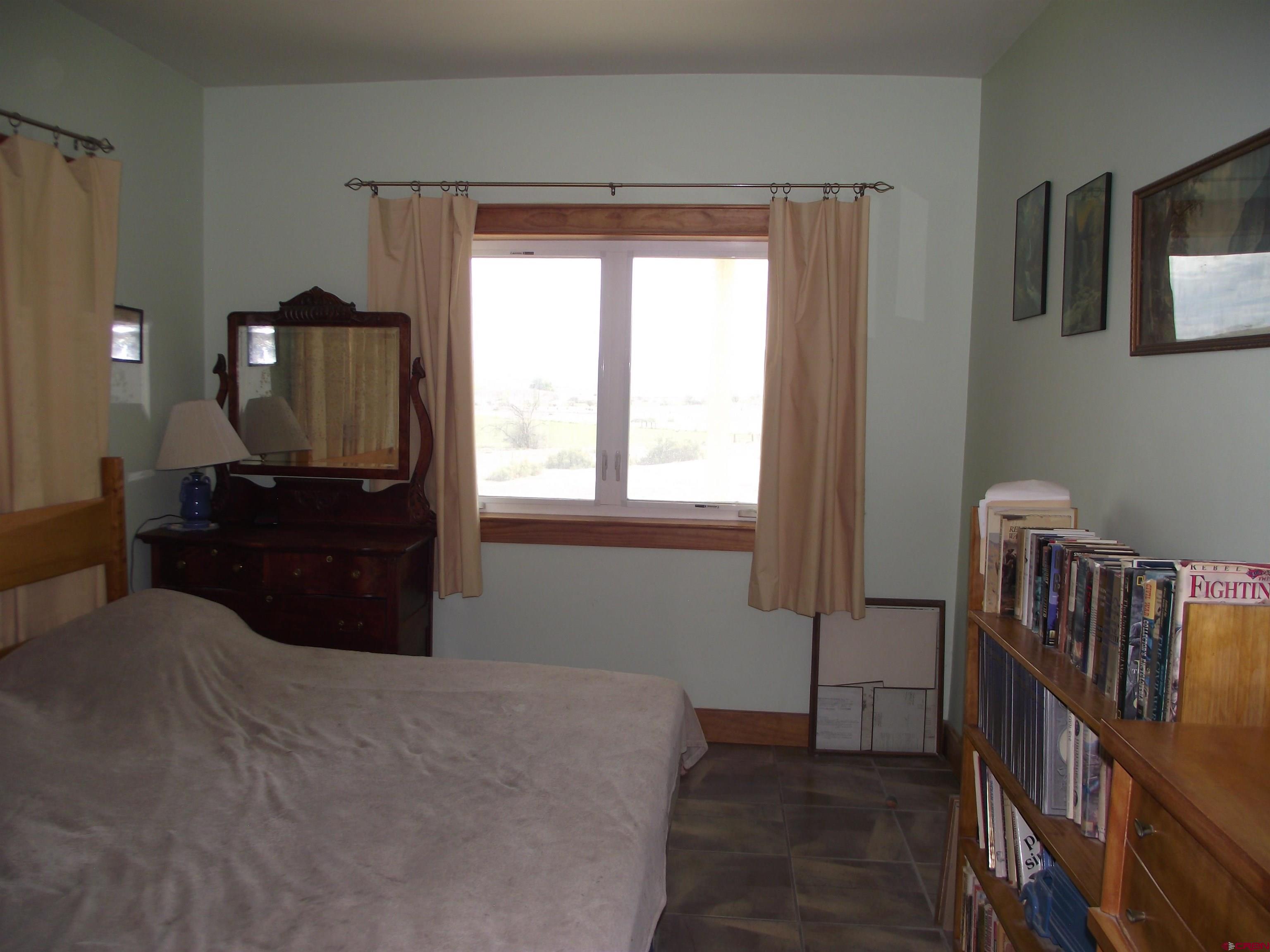 6742 2200th Road Delta, CO 81416 - Photo 45 of 45 a bedroom with a bed and wooden floor