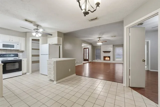 a view of a kitchen with furniture and a fireplace