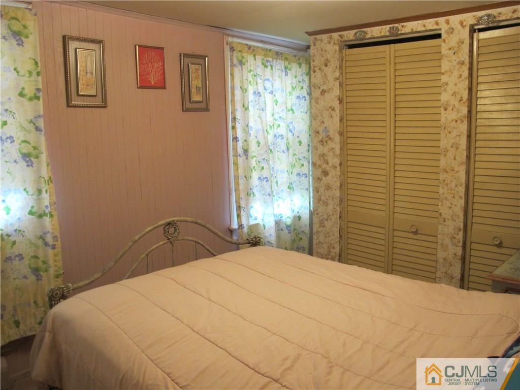 287 Terrill Road Fanwood, NJ 07023 - Photo 14 of 18 a bedroom with a bed and a window