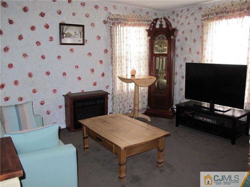 287 Terrill Road Fanwood, NJ 07023 - Photo 3 of 18 a living room with furniture and a flat screen tv