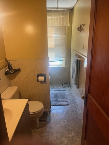 75 Winthrop Street Woonsocket, RI 02895 - Photo 26 of 30 a bathroom with a granite countertop toilet a sink a mirror and shower