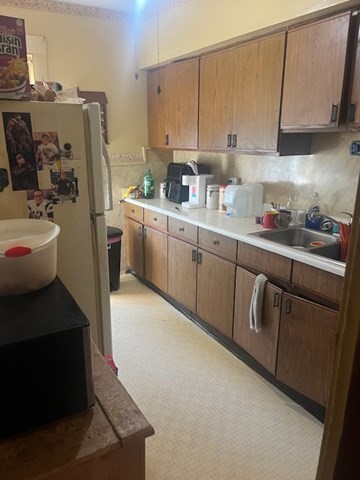 75 Winthrop Street Woonsocket, RI 02895 - Photo 27 of 30 a kitchen with refrigerator and cabinets
