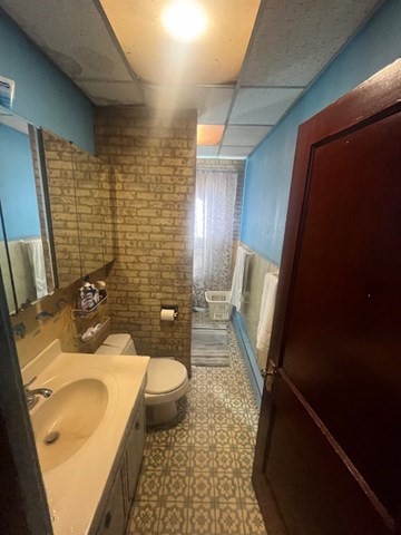 75 Winthrop Street Woonsocket, RI 02895 - Photo 7 of 30 a bathroom with a sink a toilet and shower