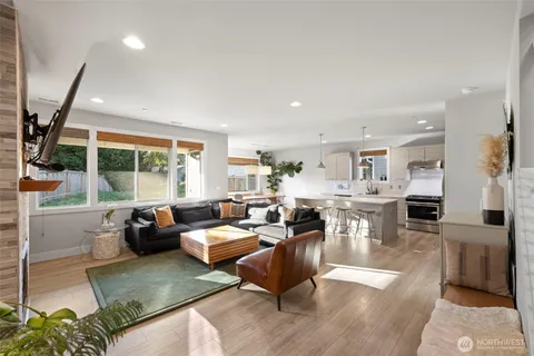 a living room with furniture large window and a table